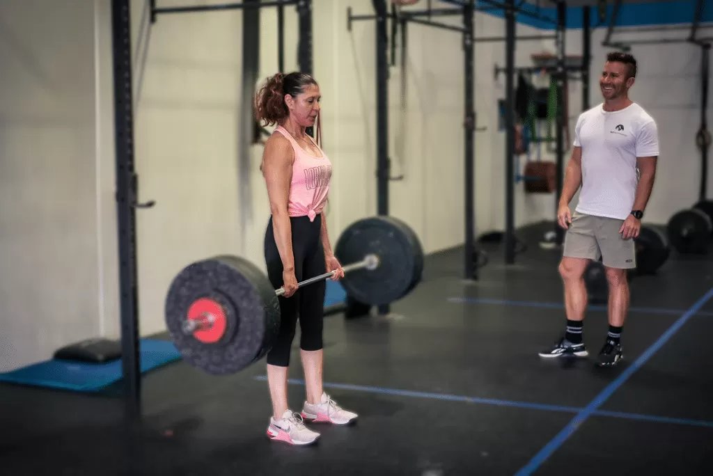 Coach demonstrating technique to capped group coaching class at 365 Performance Chipping Norton